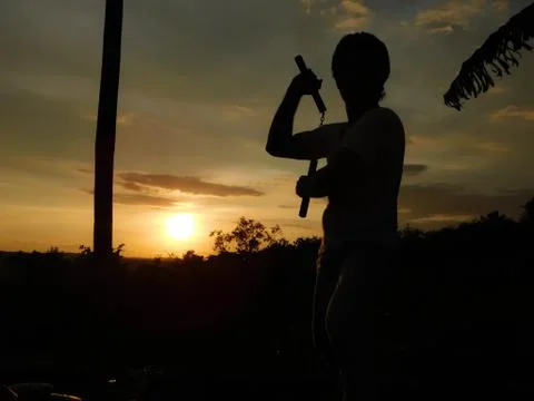 View of sunset and shadow of a man doing martial arts Stock Photos