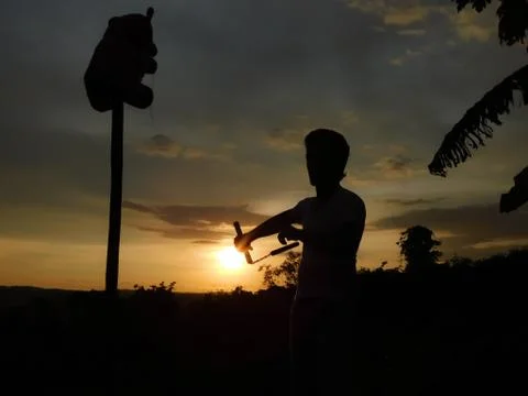 View of sunset and shadow of a man doing martial arts Stock Photos