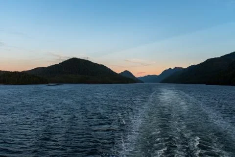 The view at sunset from the back of a ferry as it makes its way through the I Stock Photos