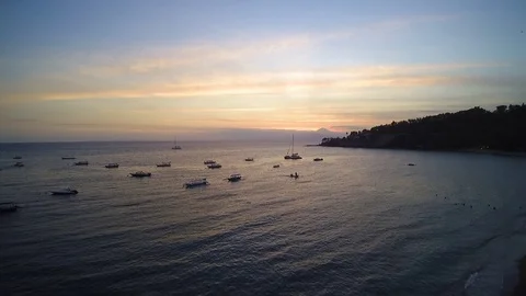 The view of sunset at beach from above with ships on the sea Stock Footage