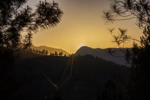 The view of the sunset behind the mountain, so beautiful Stock Photos