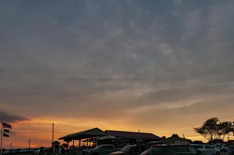 View of a Sunset with Clouds and an Orange Sky Stock Photos