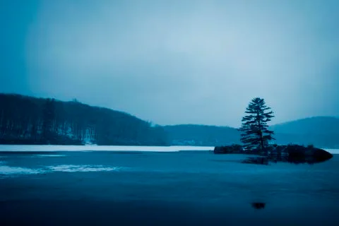 View of the sunset on the forest lake. Stock Photos