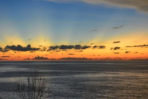 View of the sunset with the orange clouds and blue sky Stock Photos