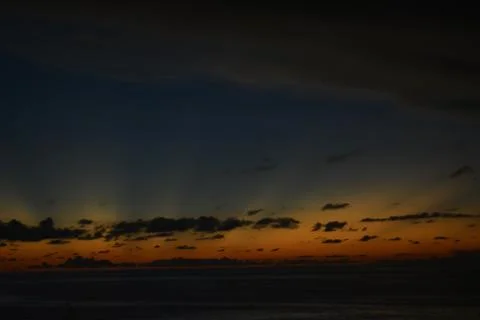 View of the sunset with the orange clouds and blue sky Stock Photos