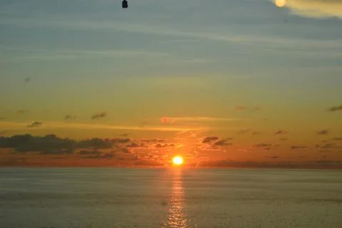 View of the sunset with the orange clouds and blue sky Stock Photos