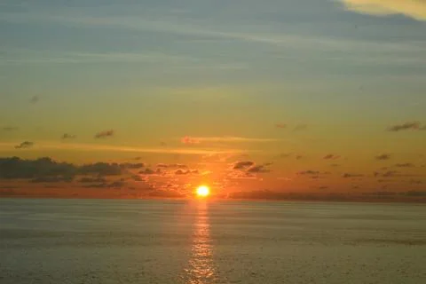 View of the sunset with the orange clouds and blue sky Stock Photos