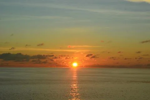 View of the sunset with the orange clouds and blue sky Stock Photos