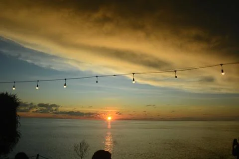 View of the sunset with the orange clouds and blue sky Stock Photos