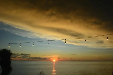 View of the sunset with the orange clouds and blue sky Stock Photos