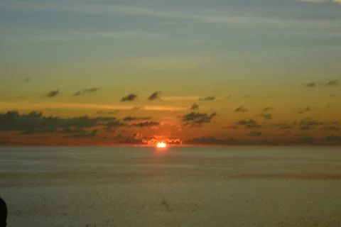 View of the sunset with the orange clouds and blue sky Stock Photos