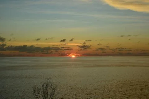 View of the sunset with the orange clouds and blue sky Stock Photos