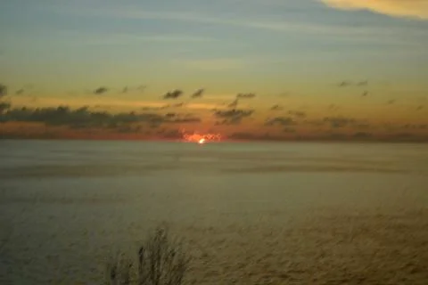 View of the sunset with the orange clouds and blue sky Stock Photos