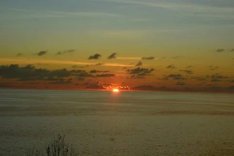 View of the sunset with the orange clouds and blue sky Stock Photos