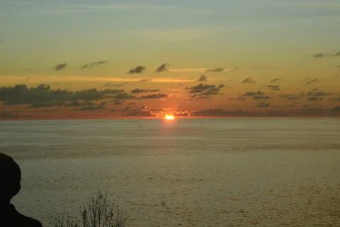 View of the sunset with the orange clouds and blue sky Stock Photos