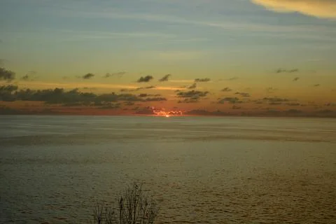View of the sunset with the orange clouds and blue sky Stock Photos