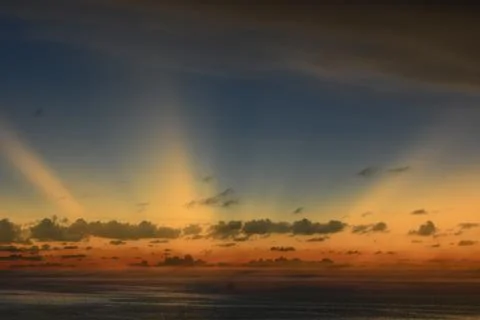 View of the sunset with the orange clouds and blue sky Stock Photos