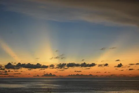 View of the sunset with the orange clouds and blue sky Stock Photos