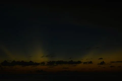 View of the sunset with the orange clouds and blue sky Stock Photos