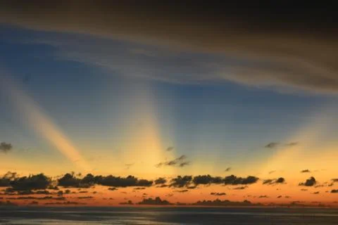 View of the sunset with the orange clouds and blue sky Stock Photos