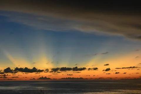 View of the sunset with the orange clouds and blue sky Stock Photos