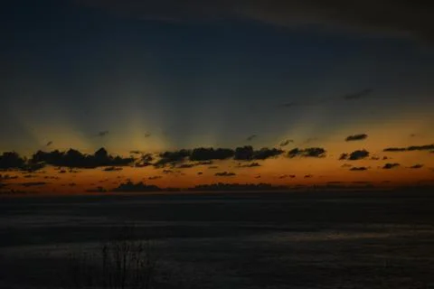 View of the sunset with the orange clouds and blue sky Stock Photos