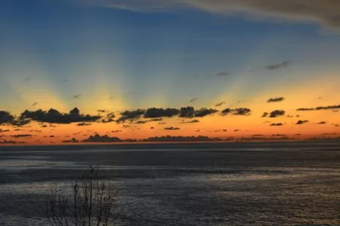 View of the sunset with the orange clouds and blue sky Stock Photos