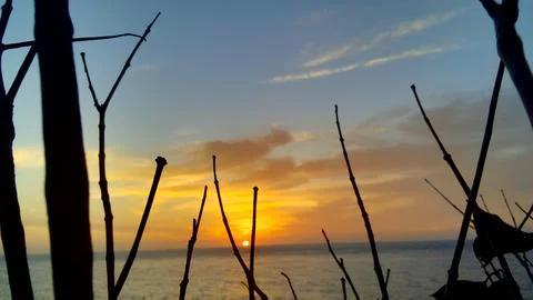 View of the sunset with the orange clouds and blue sky Stock Photos