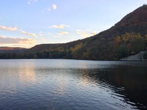 View of sunset over mountain side lake in autumn Stock Photos