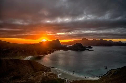 View of Sunset Over the Mountains Under Dark Clouds Stock Photos