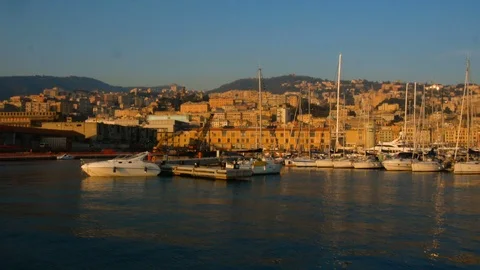View at sunset over the old port of Genoa, towards the mountainous part Stock Footage 105559114