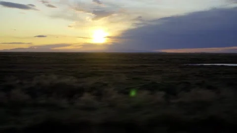 View of the sunset over the plain from a moving car. Autumn in Iceland Stock Footage 130455235