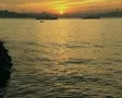 View of sunset over river with ships sailing and passing SD Footage