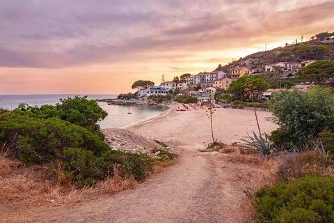 View at sunset over sandy beach of little village Seccheto at Elba Stock Photos