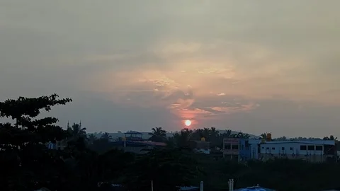 View of sunset over urban area with buildings silhouetted against warm glow.. Stock Footage 336042883