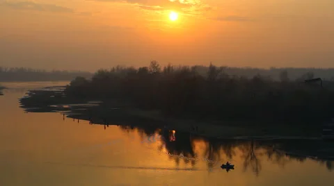 View of the sunset on the river with a floating fishing boat Stock Footage 44764169