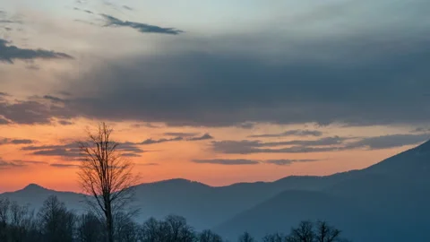 View of Sunset sun and clouds above mountains Stock Footage 142790103