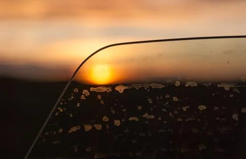 View of the sunset through a slightly open car window Stock Photos