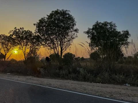 View of Sunset while driving alongside the roads of Rajasthan Stock Photos