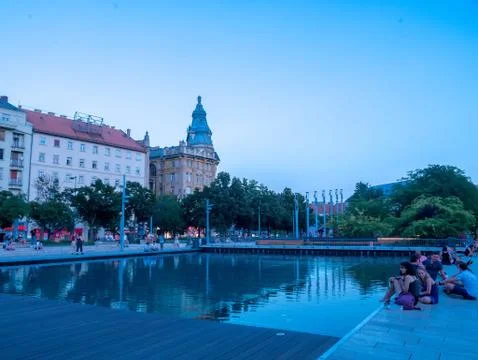 View on the sunset while the people resting on the Francis square in Budapest Stock Photos