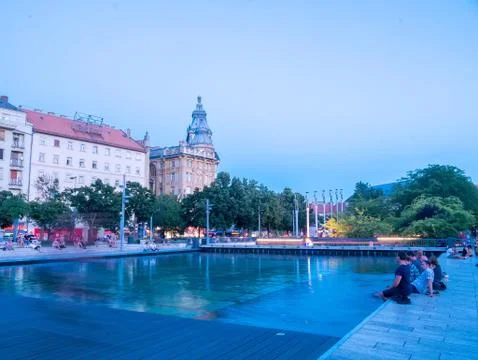 View on the sunset while the people resting on the Francis square in Budapest Stock Photos