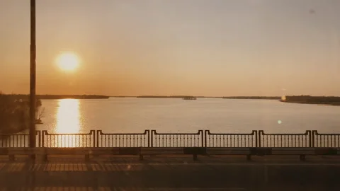 View of the sunset from the window of a moving bus across the bridge Stock Footage 152266658