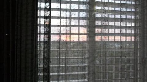 View of the sunset from the window  through transparent curtain Видео 98422243