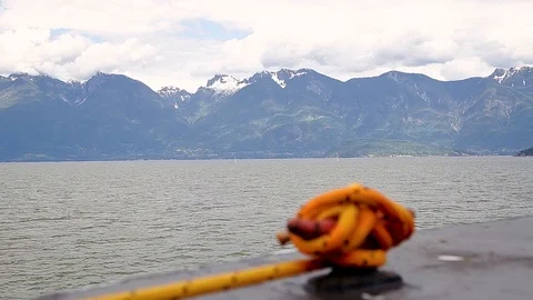 A view of the Sunshine Coast as seen from the deck of a ferry with a rope cleat Stock Footage 96481515