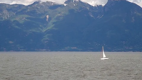 A view of the Sunshine Coast as seen from the deck of a ferry with a sailboat in Stock Footage 96482344