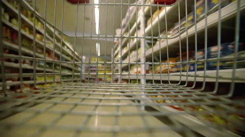 View of the supermarket through the empty shopping cart. Close up mall trolley g Vidéo 169828543