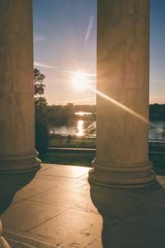 A view of supporting columns with the sun setting in between Stock Photos