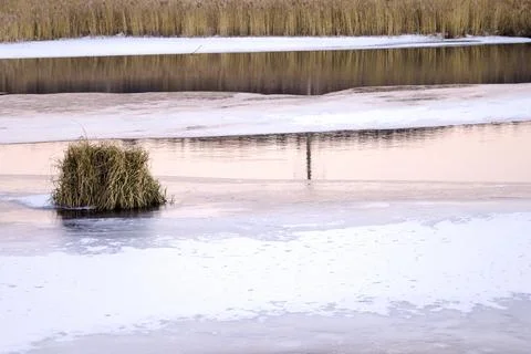 A view of the surface of the lake covered with crust of ice and snow Stock Photos