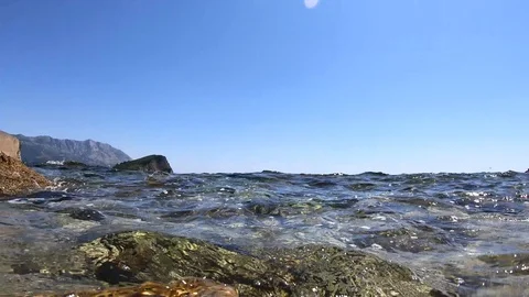 View from the surface of the sea on the waves, the bottom and the rocks Stock Footage 111913739