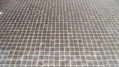 View of the surface of the water in swimming pool with sunlight reflected Video stock 258749828